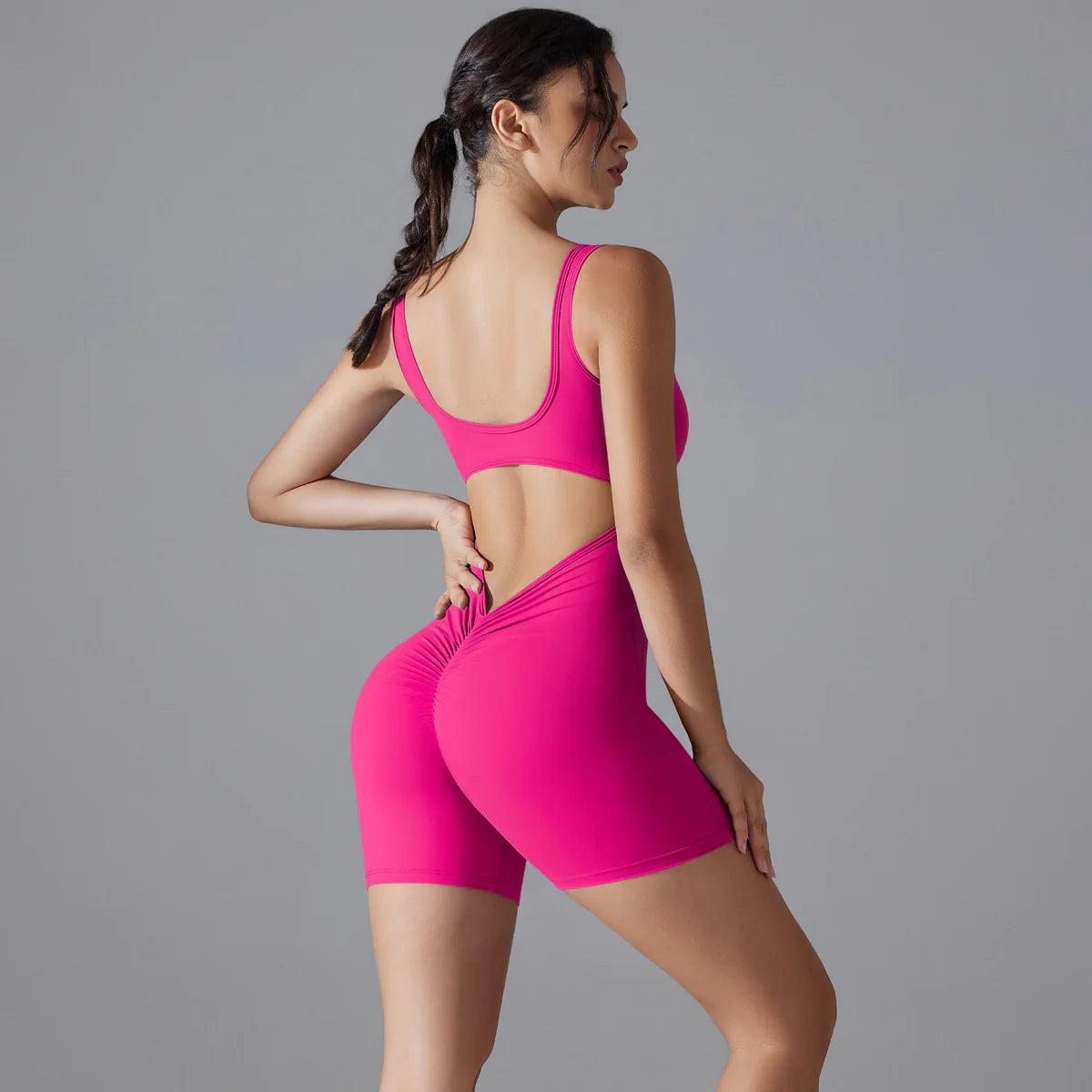 Pointe V-back scrunch shorts romper in hot pink, back